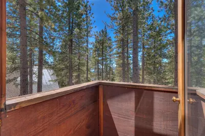 a balcony with a view of the woods at Base Camp at Dollar Point by Tahoe Getaways - Hot Tub, Large Deck, Wood Fireplace, Short Drive to Ski Resorts! in Tahoe City