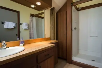 a bathroom with a sink and a mirror and a tub at Alpine Darling- Hot Tub- Pet Friendly- 3 Minute Drive to Palisades Tahoe in Alpine Meadows