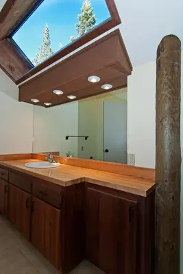 a bathroom with a sink and a large mirror at Alpine Darling- Hot Tub- Pet Friendly- 3 Minute Drive to Palisades Tahoe in Alpine Meadows