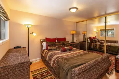 a bedroom with a bed and a large mirror at 1 Alpine Terrace-renovated condo private hot tub in Incline Village
