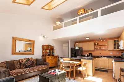 a living room with a couch and a table and a kitchen at 1 Alpine Terrace-renovated condo private hot tub in Incline Village