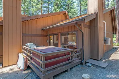 a house with a hot tub on the side of it at 1 Alpine Terrace-renovated condo private hot tub in Incline Village