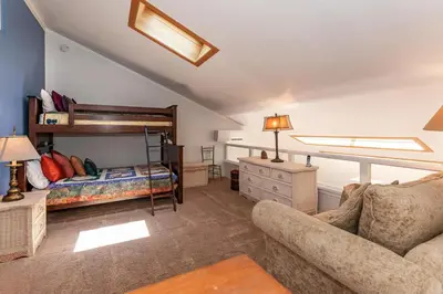 a bedroom with a bunk bed and a couch at 1 Alpine Terrace-renovated condo private hot tub in Incline Village
