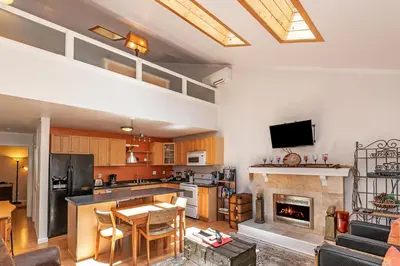 a kitchen and living room with a fireplace at 1 Alpine Terrace-renovated condo private hot tub in Incline Village
