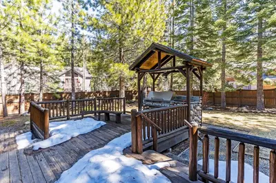 a gazebo with a grill on a wooden deck at 1138 Lakeshore - One-of-a-kind Lakeshore Boulevard log cabin in Incline Village