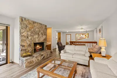 a living room with a large stone fireplace at 1 Sky Lake - walk to town in Incline Village