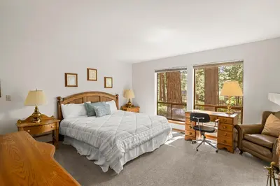 a bedroom with a bed and a desk and a chair at 1 Sky Lake - walk to town in Incline Village