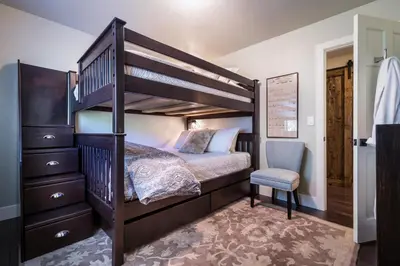 a bedroom with a bunk bed and a chair at 101 McCloud - Simply Elegant in Incline Village