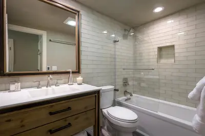 a bathroom with a toilet and a sink and a tub at 101 McCloud - Simply Elegant in Incline Village