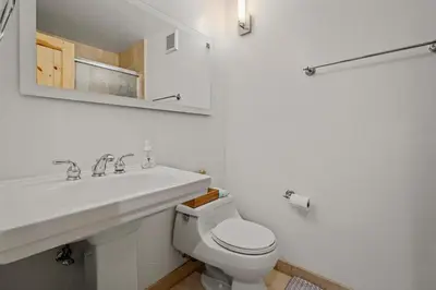 a white bathroom with a sink and a toilet at Magnificent 2-bedroom, 2-bath lakefront complex in Incline Village