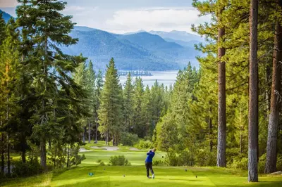 a man is playing golf on a golf course at 107 McCloud - Highly Sought After Complex in Incline Village