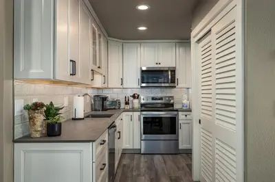 a kitchen with white cabinets and a counter top at 128 McCloud - Luxury Couples Retreat in Incline Village
