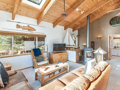 a living room with a couch and a tv at Fantastic Lakeview house with large decks! in Incline Village