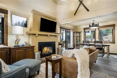 a living room with a couch and a fireplace at 1331 Zurich Lane - Modern Mountain Chalet in Incline Village