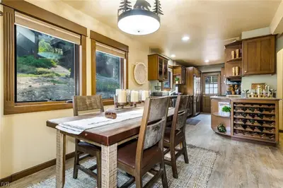 a kitchen and dining room with a wooden table and chairs at 1331 Zurich Lane - Modern Mountain Chalet in Incline Village