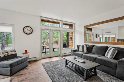 a living room with a couch and a table at 153 McCloud The perfect location! Enjoy the sun drenched deck in Incline Village