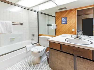 a bathroom with a toilet and a sink and a tub at 168 Forest Pines - walk to Lakeshore Blvd community pool and hot tub in Incline Village