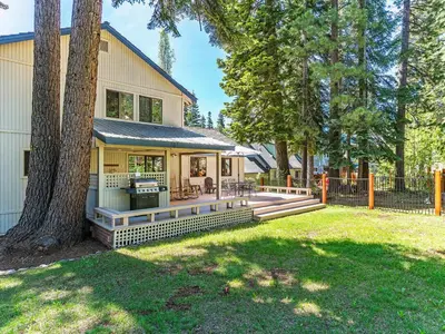 a house with a backyard with a tree at A great mountain home offering amenities that makes for a great getaway in Lake Tahoe in Incline Village