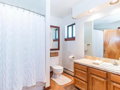 a bathroom with a toilet and a sink and a mirror at A great mountain home offering amenities that makes for a great getaway in Lake Tahoe in Incline Village