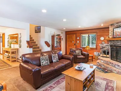 a living room with a leather couch and a fireplace at A great mountain home offering amenities that makes for a great getaway in Lake Tahoe in Incline Village