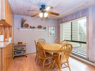 a dining room with a table and chairs and a ceiling fan at 214 Forest Pines Nicely Decorated 4 Bedroom Condo in Incline Village