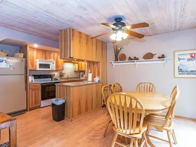 a kitchen with a table and a ceiling fan at 214 Forest Pines Nicely Decorated 4 Bedroom Condo in Incline Village