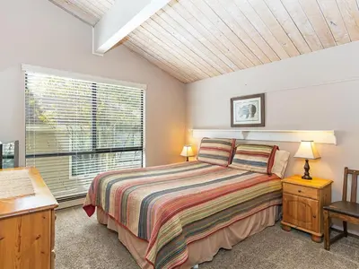 a bedroom with a large bed and a window at 214 Forest Pines Nicely Decorated 4 Bedroom Condo in Incline Village
