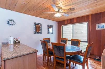 a dining room with a table and a ceiling fan at Forest Pines Condo #216 in Incline Village