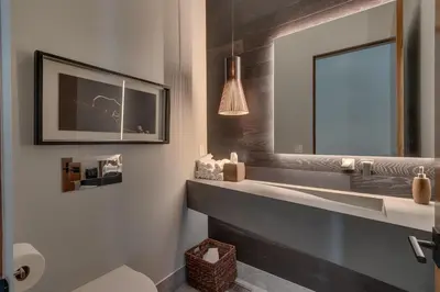 a bathroom with a sink and a mirror at Elegance at Schaffer's Mill - Luxury 4 BR, Private Hot Tub, Pet Friendly! in Truckee