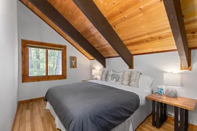 a bedroom with a bed and a wooden ceiling at Four Summits- Hot Tub- Pool Table- Short Drive to Ski Resorits in Carnelian Bay