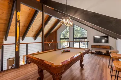 a pool table in the middle of a room at Four Summits- Hot Tub- Pool Table- Short Drive to Ski Resorits in Carnelian Bay