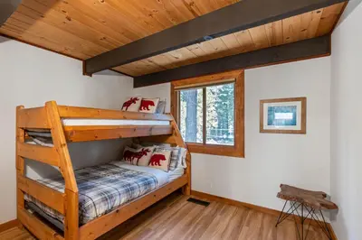 a bedroom with a bunk bed in a cabin at Four Summits- Hot Tub- Pool Table- Short Drive to Ski Resorits in Carnelian Bay