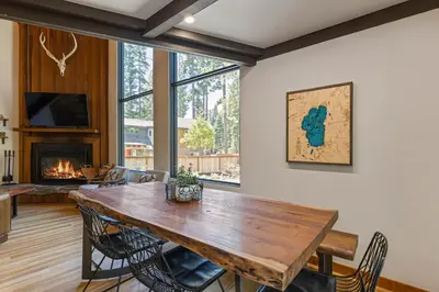 a dining room with a wooden table and a fireplace at Four Summits- Hot Tub- Pool Table- Short Drive to Ski Resorits in Carnelian Bay