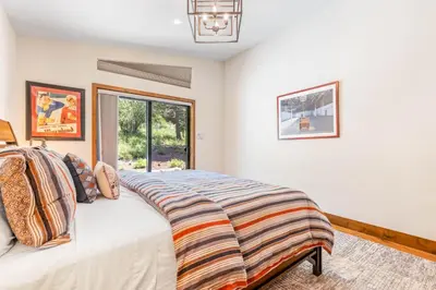 a bedroom with a bed and a window at Harmony at Tahoe Donner - Ultra Modern 4 BR, Hot Tub, Game Room, Amenity Access in Truckee