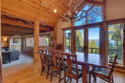 a dining room with a wooden table and chairs at Huckleberry Haven by Tahoe Getaways - Luxury Lake View 4BR in North Lake with Private Hot Tub in Carnelian Bay