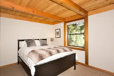 a bedroom with a bed and a wooden ceiling at Juniper at Alpine - Private Hot tub, Pet Friendly & Free Shuttle to Slopes in Olympic Valley