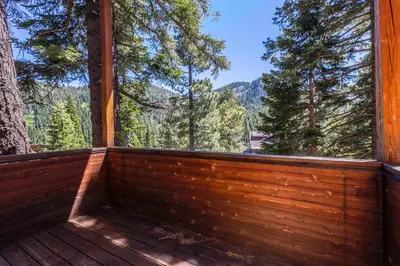a screened in porch with a view of the mountains at Juniper at Alpine - Private Hot tub, Pet Friendly & Free Shuttle to Slopes in Olympic Valley