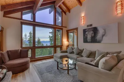 a living room with two couches and a table at Kings Way Lake View by Tahoe Getaways - Spacious 4 BR w Private Hot Tub, Pool Table! in Tahoe Vista