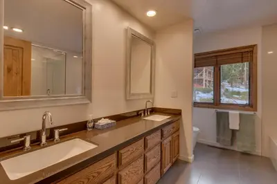 a bathroom with two sinks and a mirror at Kings Way Lake View by Tahoe Getaways - Spacious 4 BR w Private Hot Tub, Pool Table! in Tahoe Vista