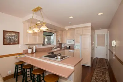 a kitchen with a large island with a counter top at Lakeside Escape - Beautiful Lakefront, Pier, Wood Fireplace, Private Hot Tub in Tahoe Vista