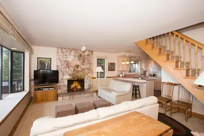 a living room with a couch and a fireplace at Lakeside Escape - Beautiful Lakefront, Pier, Wood Fireplace, Private Hot Tub in Tahoe Vista