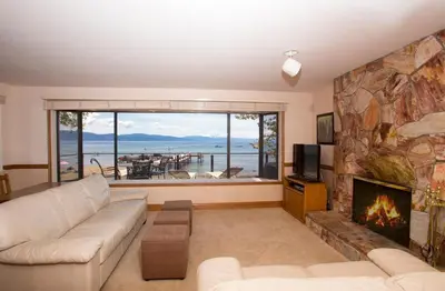 a living room with a couch and a fireplace at Lakeside Escape - Beautiful Lakefront, Pier, Wood Fireplace, Private Hot Tub in Tahoe Vista