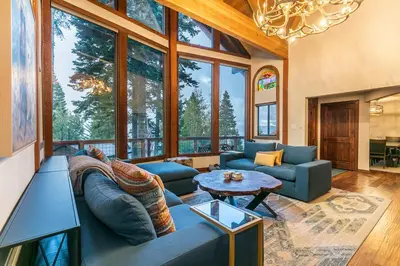 a living room with a couch and a table at Lake of the Sky at Dollar Point - Stunning 4BR,4BA w Lake Views, Hot Tub and Pet-friendly in Tahoe City