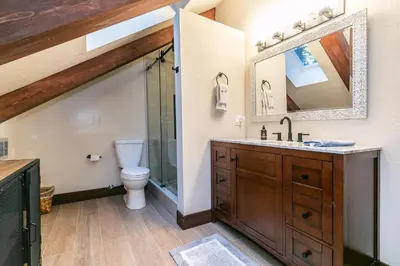 a bathroom with a toilet and a sink and a mirror at Lake of the Sky at Dollar Point - Stunning 4BR,4BA w Lake Views, Hot Tub and Pet-friendly in Tahoe City