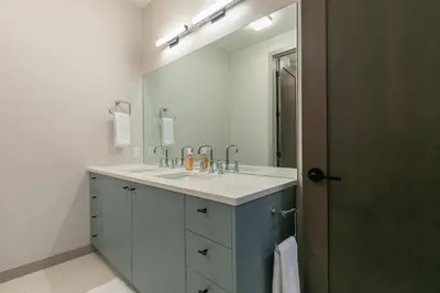 a bathroom with a sink and a large mirror at Larkspur Luxe at Northstar- 4 BR with Pool, Gym, Access - Walk to Village, Private Hot Tub in Truckee