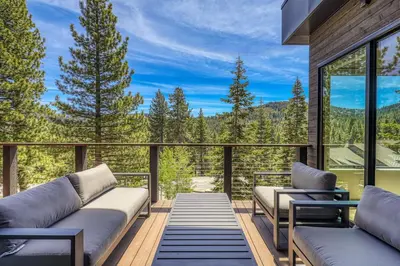a balcony with couches and a view of the mountains at Larkspur Luxe at Northstar- 4 BR with Pool, Gym, Access - Walk to Village, Private Hot Tub in Truckee