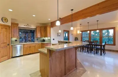 a large kitchen with a large island in the middle at Look Out Lodge - On North Shore w Lake View, Hot Tub, Pool Table and Pet Friendly in Kings Beach
