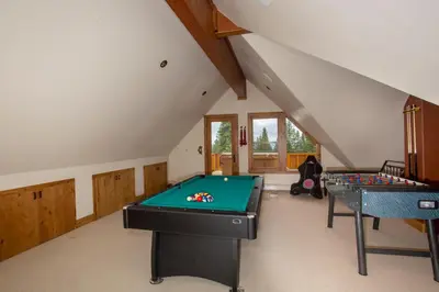 a room with a pool table and two tables at Look Out Lodge - On North Shore w Lake View, Hot Tub, Pool Table and Pet Friendly in Kings Beach