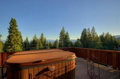 a suitcase sitting on top of a deck at Look Out Lodge - On North Shore w Lake View, Hot Tub, Pool Table and Pet Friendly in Kings Beach