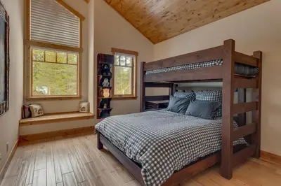 a bedroom with a bed and a wooden ceiling at Majestic Woods at Tahoe Donner - High End Craftsman w Game Room, Hot Tub, Amenity Access in Truckee